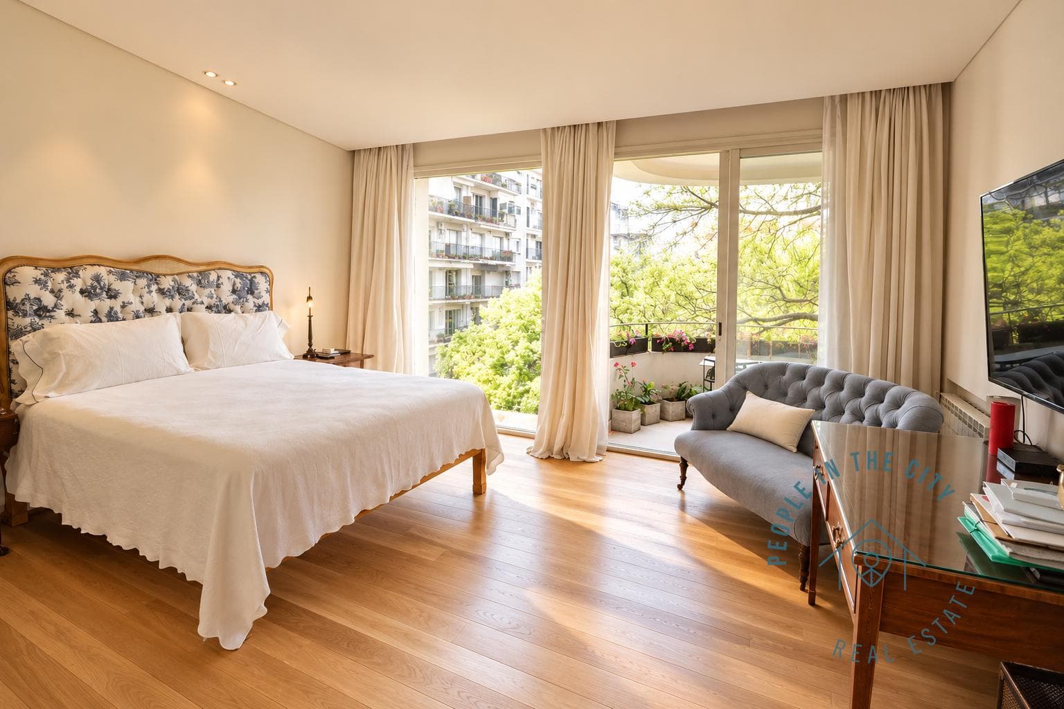 Dormitorio principal con cama, ventanal con salida al balcón.
