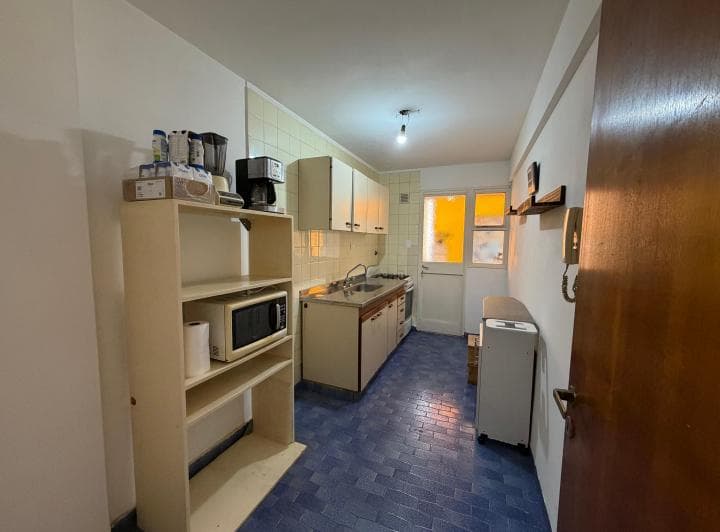 Cocina completa con mesada, bacha, anafe, alacenas y ventana.
